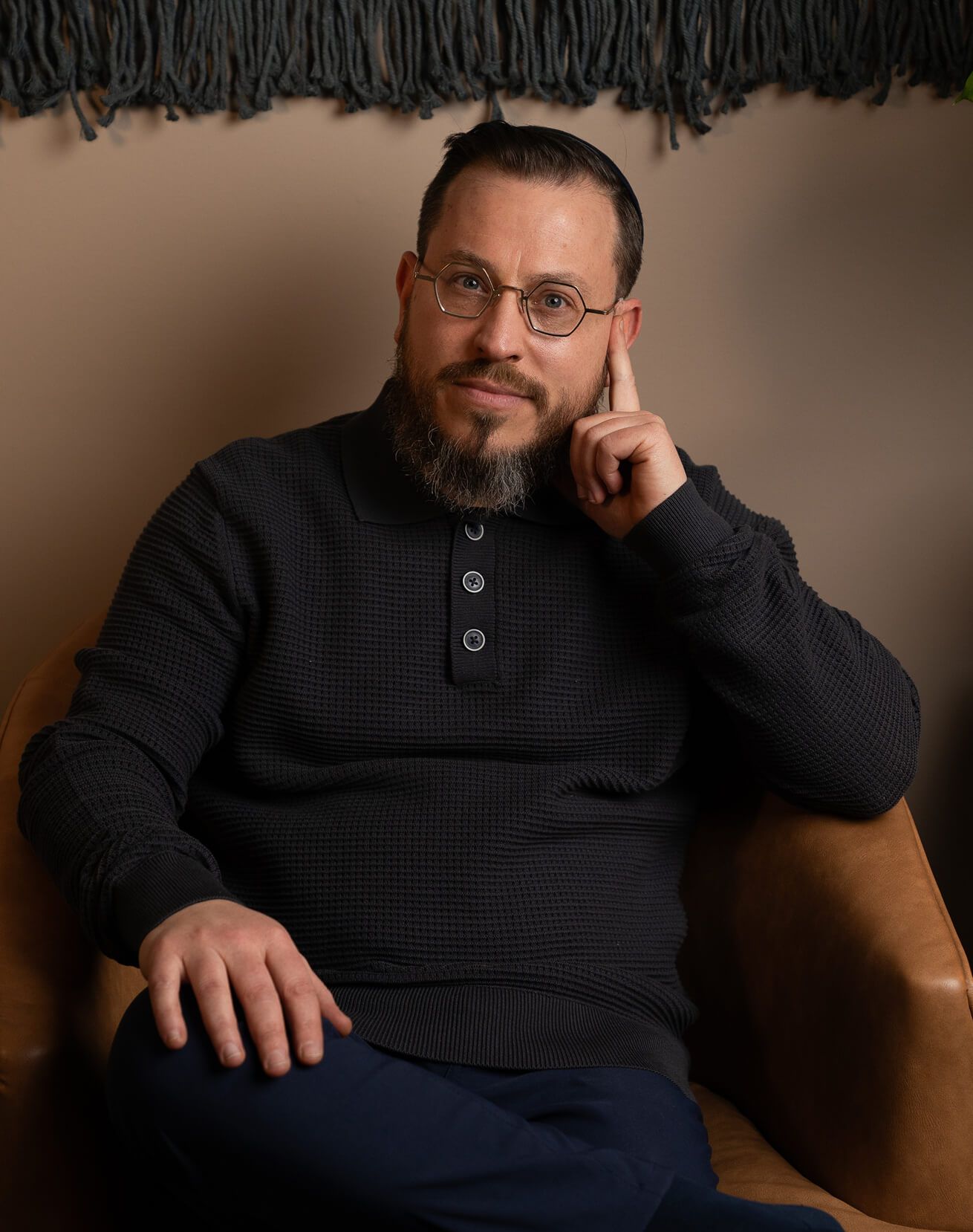 Chaim sitting in an armchair