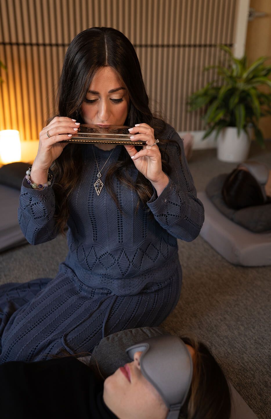 Chanie playing a harmonica during a session