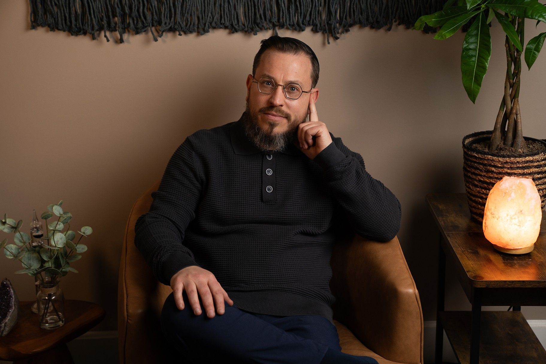 Chaim sitting in an armchair